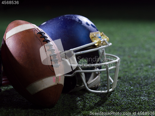 Image of closeup of american football and helmet