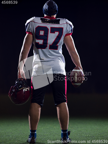 Image of rear view of young confident American football player