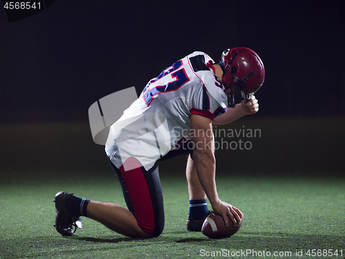 Image of American football player starting football game