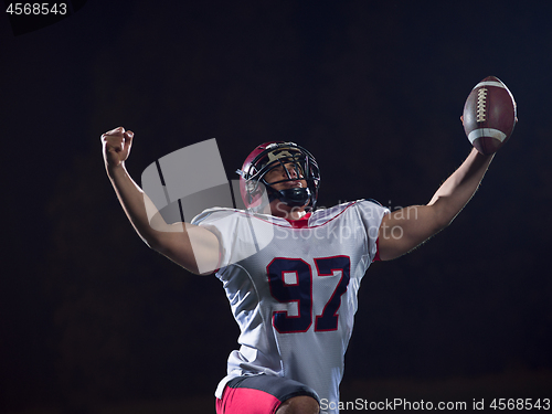 Image of american football player celebrating after scoring a touchdown