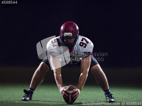 Image of American football player starting football game