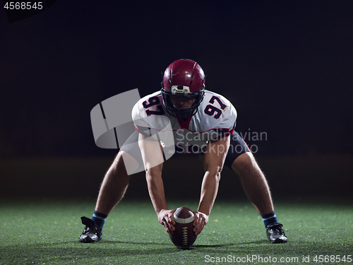 Image of American football player starting football game