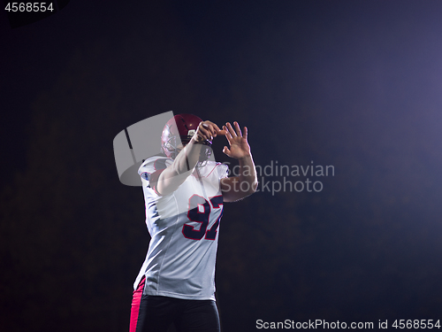 Image of american football player throwing rugby ball