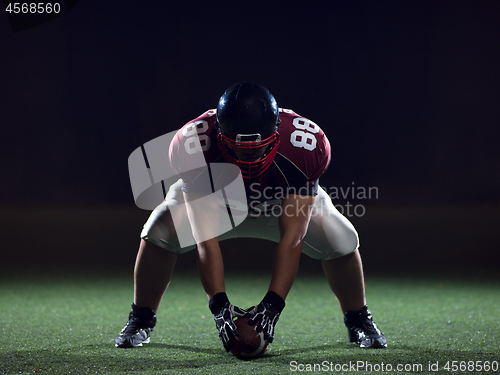 Image of American football player starting football game