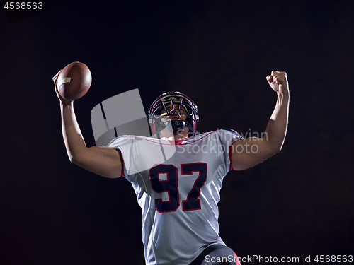 Image of american football player celebrating after scoring a touchdown