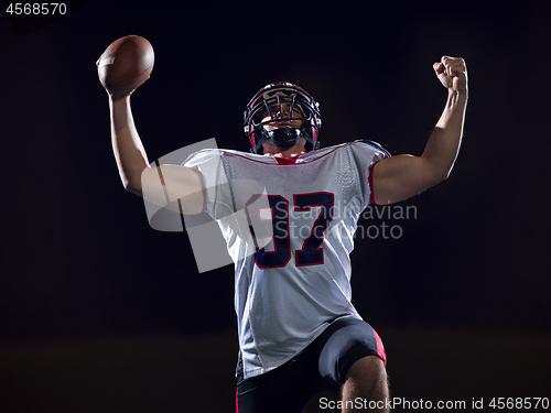 Image of american football player celebrating after scoring a touchdown