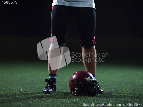 Image of closeup of american football player and helmet