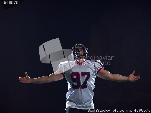 Image of american football player celebrating after scoring a touchdown