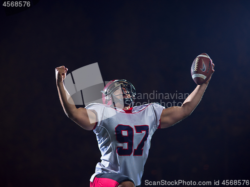 Image of american football player celebrating after scoring a touchdown