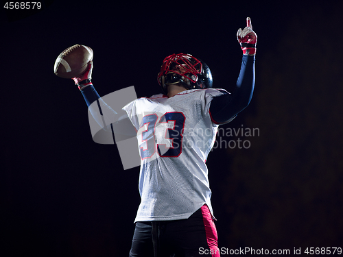 Image of american football player celebrating after scoring a touchdown