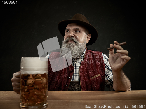 Image of Germany, Bavaria, Upper Bavaria, man with beer dressed in in traditional Austrian or Bavarian costume