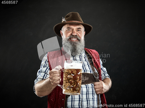 Image of Germany, Bavaria, Upper Bavaria, man with beer dressed in in traditional Austrian or Bavarian costume