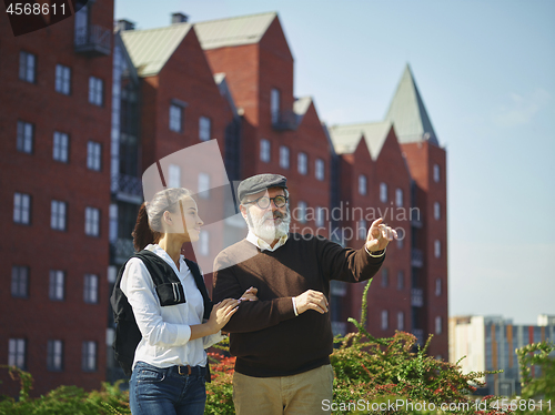 Image of Portrait of young girl embracing grandfather at park