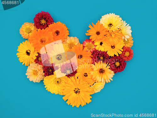 Image of Yellow calendulas and red dahlias in a flower heart
