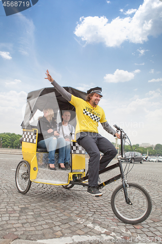 Image of man driving in bicycle taxi