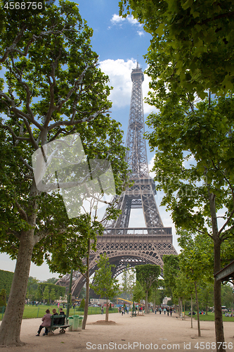 Image of View of the Eiffel Tower from a beautiful green park against the blue sky, Paris France