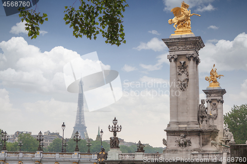 Image of Golden monuments on the bridge Pont Alexander III bridge in Paris overlooking the background the eiffel tower