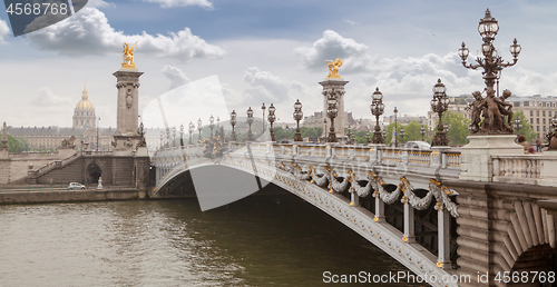 Image of Panorama with Pont Alexandre III Bridge and overlooking the old city, cloudy day. France Paris