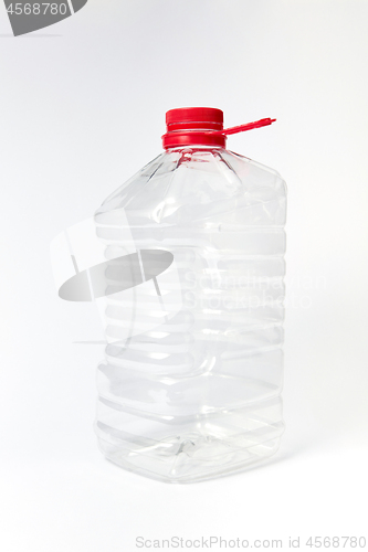 Image of Mock-up big transparent canister for liquid on a light background.