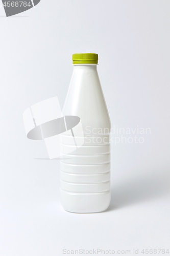 Image of White plastic bottle for milk, mock up on a light background.