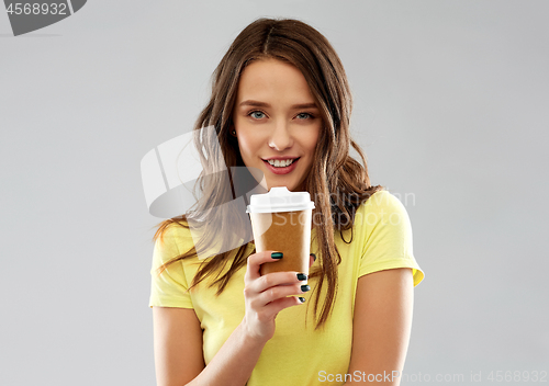 Image of young woman or teenage girl drinking coffee