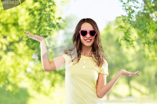 Image of teenage girl in heart-shaped sunglasses