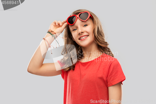 Image of happy teenage girl in red heart shaped sunglasses