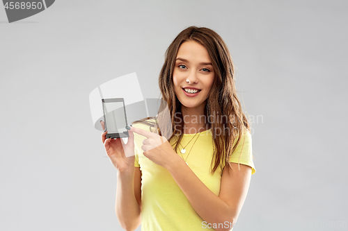 Image of young woman or teenage girl holding smartphone