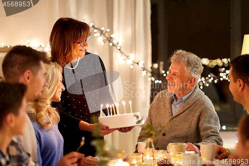 Image of happy family having birthday party at home