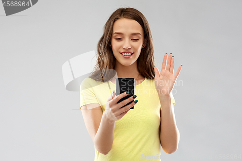 Image of smiling teenage girl having video call smartphone