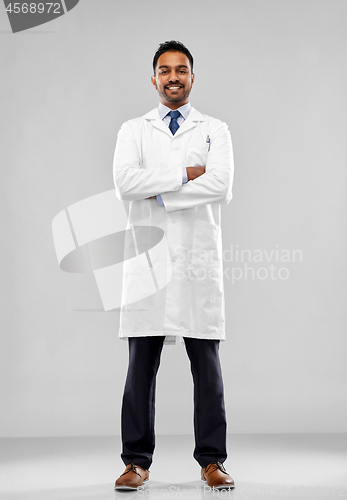 Image of smiling male doctor or scientist in white coat