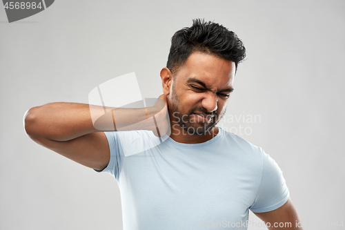 Image of unhealthy indian man suffering from neck pain