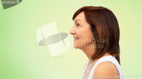 Image of profile of smiling senior woman over white