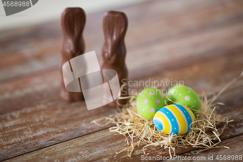 Image of easter eggs in straw nest and chocolate bunnies