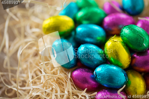 Image of close up of chocolate easter eggs in straw nest