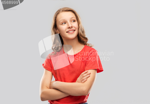 Image of happy teenage girl in red with crossed arms