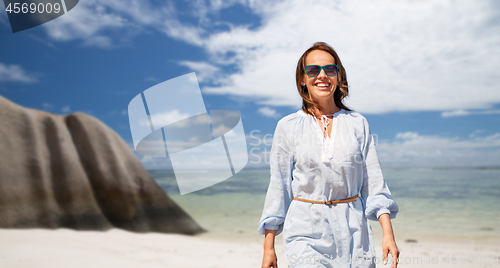 Image of happy woman over seychelles island tropical beach