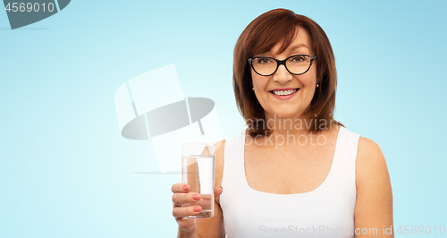 Image of senior woman in glasses with glass of water