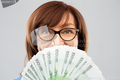 Image of senior woman with hundreds of euro money banknotes