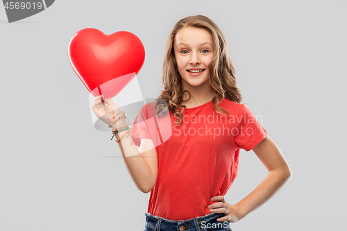 Image of smiling teenage girl with red heart shaped balloon