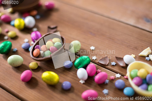 Image of chocolate eggs and candy drops on wooden table