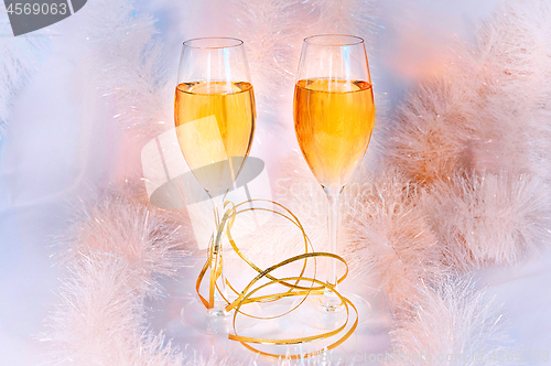 Image of Two glasses of wine and tinsel. Holiday concept.