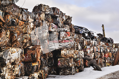 Image of A pile of compressed cars in blocks for processing