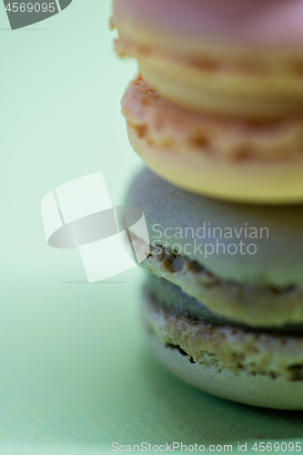 Image of Macro shot of stack of macarons over green mint background