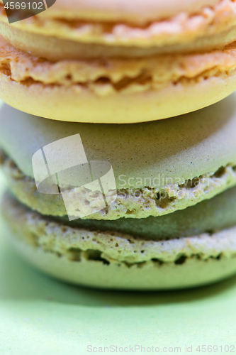 Image of Macro shot of stack of macarons over green mint background