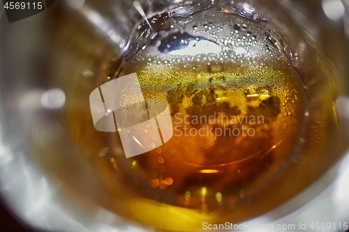 Image of Drinking beer closeup inside the pint glass