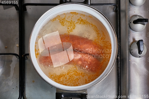 Image of Boiling sausages on stove