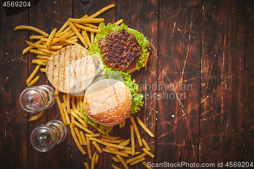 Image of Two tasty grilled home made burgers with beef, tomato, onion and lettuce