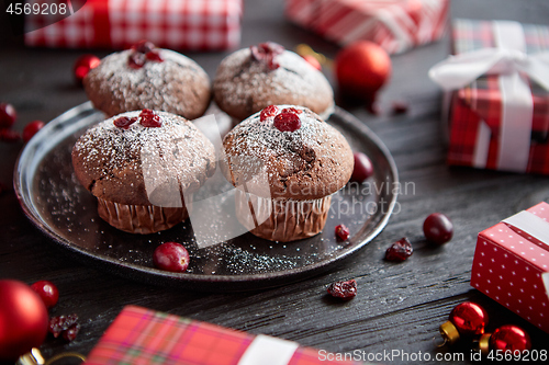 Image of Christmas chocolate delicious muffins served on black ceramic plate