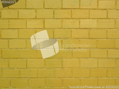 Image of Brick wall painted in golden color